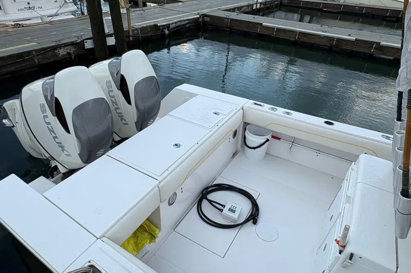 Slide: The Image of 2006 Regulator 32 Forward Seating boat with twin Suzuki engines docked at marina. - 7