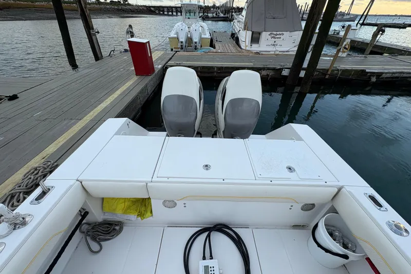 Slide: The Image of 2006 Regulator 32 Forward Seating boat docked with twin engines, rear view. - 8