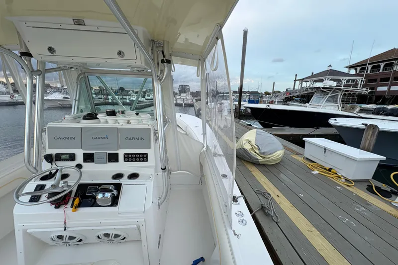 Slide: The Image of 2006 Regulator 32 Forward Seating boat at marina with Garmin navigation system. - 9