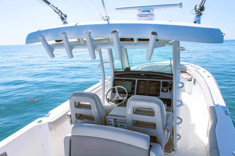 Slide: The Image of 2017 Boston Whaler 330 Outrage boat interior with helm and ocean view. - 3