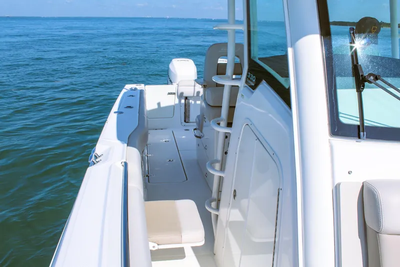 Slide: The Image of 2017 Boston Whaler 330 Outrage boat on calm ocean waters, showcasing sleek design. - 7