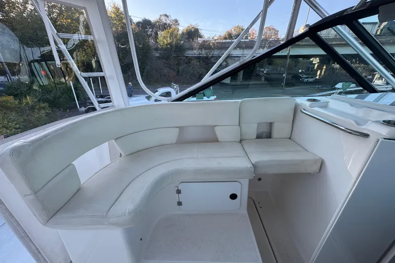 Slide: The Image of 2005 Tiara Yachts 2900 Open interior with white seating and sleek design. - 10