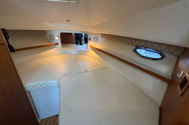 Slide: The Image of 2005 Tiara Yachts 2900 Open cabin interior with cozy bed and porthole window. - 14