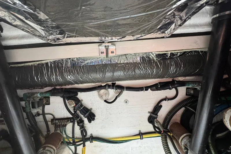 Slide: The Image of Engine compartment of a 2005 Tiara Yachts 2900 Open, showing wiring and insulation. - 20
