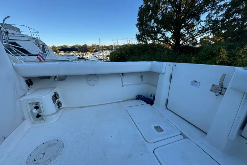 Slide: The Image of 2005 Tiara Yachts 2900 Open boat deck with marina view and American flag. - 5