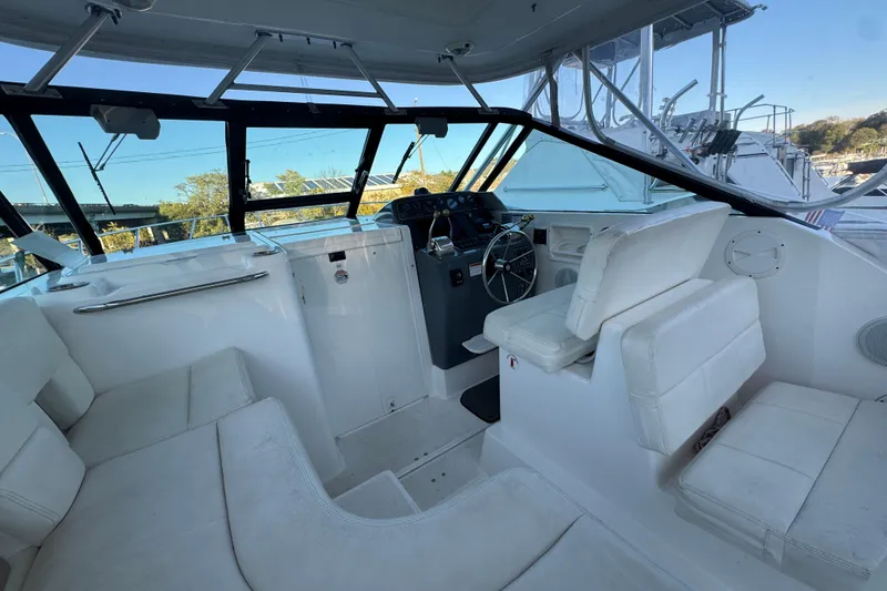 Slide: The Image of 2005 Tiara Yachts 2900 Open interior with white seating and steering wheel. - 8