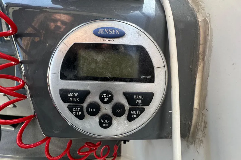 Slide: The Image of Jensen JWR200 radio on 2014 Larson Cabrio 265 boat dashboard. - 13