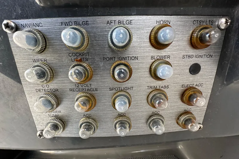 Slide: The Image of Control panel of a 2014 Larson Cabrio 265 boat with labeled switches and knobs. - 15