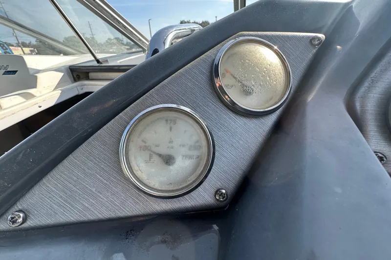 Slide: The Image of Dashboard gauges of a 2014 Larson Cabrio 265 boat, close-up view. - 19