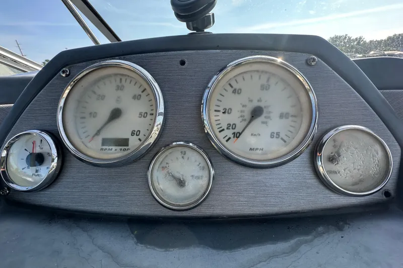 Slide: The Image of Dashboard of a 2014 Larson Cabrio 265 boat with speedometer and fuel gauge. - 20