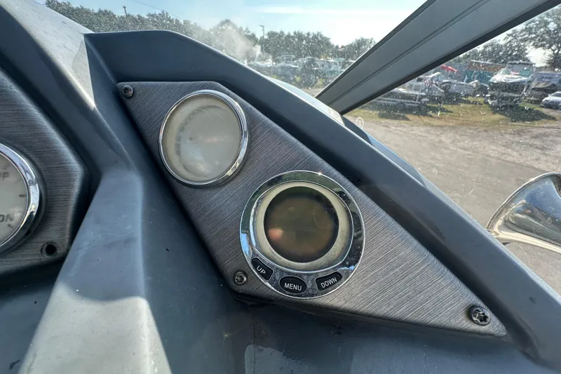 Slide: The Image of Dashboard of a 2014 Larson Cabrio 265 boat with gauges and controls. - 21