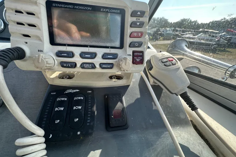 Slide: The Image of 2014 Larson Cabrio 265 boat dashboard with radio and control panel. - 23