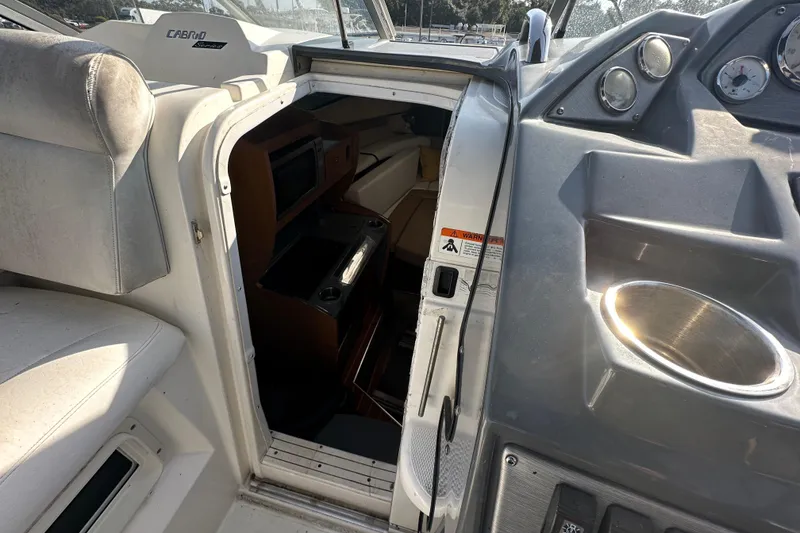 Slide: The Image of 2014 Larson Cabrio 265 boat interior with cabin entrance and dashboard view. - 25