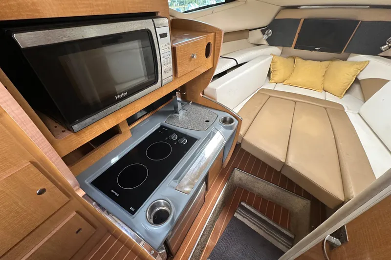 Slide: The Image of 2014 Larson Cabrio 265 interior with kitchenette and cozy seating area. - 27
