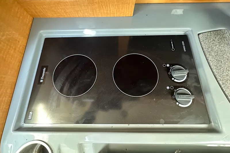 Slide: The Image of Built-in Dometic cooktop on 2014 Larson Cabrio 265 boat kitchen counter. - 30