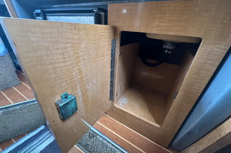 Slide: The Image of Open wooden cabinet in 2014 Larson Cabrio 265 boat interior. - 33