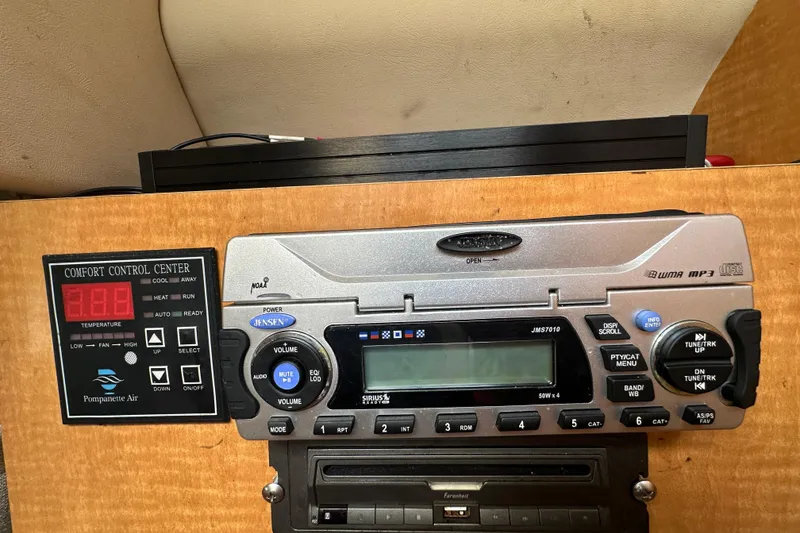Slide: The Image of 2014 Larson Cabrio 265 control panel with Jensen audio system and comfort control center. - 44