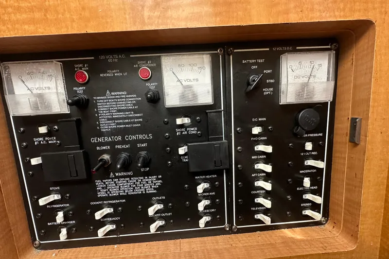 Slide: The Image of Control panel of a 2014 Larson Cabrio 265 boat, featuring generator and electrical controls. - 45