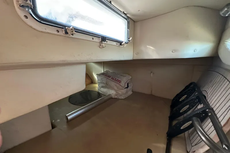 Slide: The Image of 2014 Larson Cabrio 265 cabin interior with window and storage space. - 46
