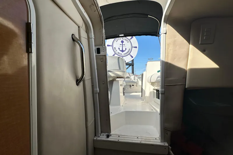 Slide: The Image of Interior view of 2014 Larson Cabrio 265 boat, showing cabin entrance and seating area. - 47