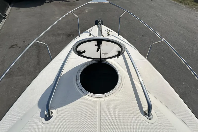 Slide: The Image of 2014 Larson Cabrio 265 boat deck with hatch and railing. - 50