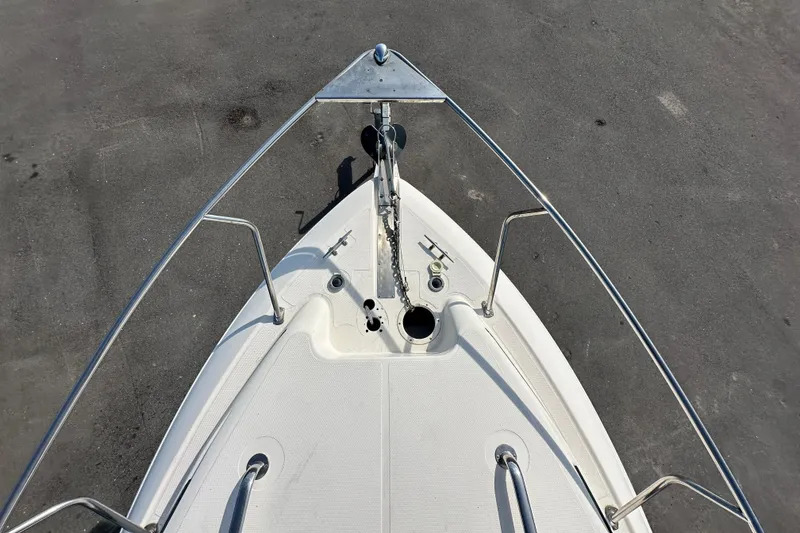 Slide: The Image of Bow view of 2014 Larson Cabrio 265 boat with anchor and railings. - 51