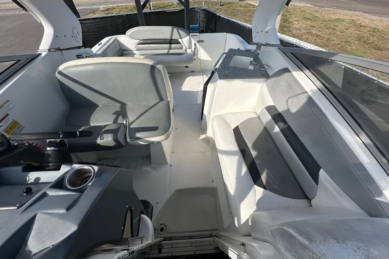 Slide: The Image of 2014 Larson Cabrio 265 boat interior with seating and helm, showcasing spacious design. - 55