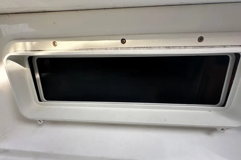 Slide: The Image of Boat window on a 2014 Larson Cabrio 265, featuring a sleek white frame. - 57