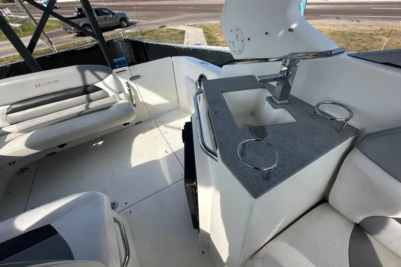 Slide: The Image of 2014 Larson Cabrio 265 boat interior with seating and countertop sink. - 58