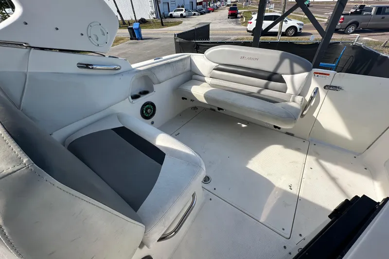 Slide: The Image of 2014 Larson Cabrio 265 boat interior with white seating and modern design. - 64