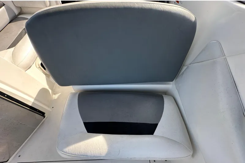 Slide: The Image of 2014 Larson Cabrio 265 boat seat, featuring gray and white upholstery. - 65
