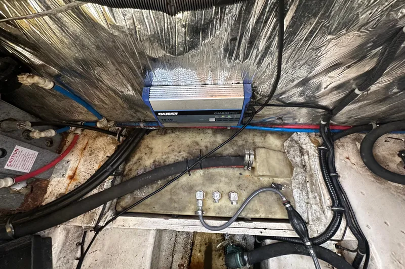 Slide: The Image of Engine compartment of a 2014 Larson Cabrio 265 boat with wiring and battery charger. - 68