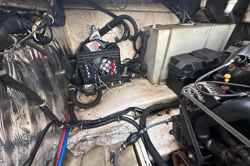 Slide: The Image of Engine compartment of a 2014 Larson Cabrio 265 boat, showing various mechanical components. - 71