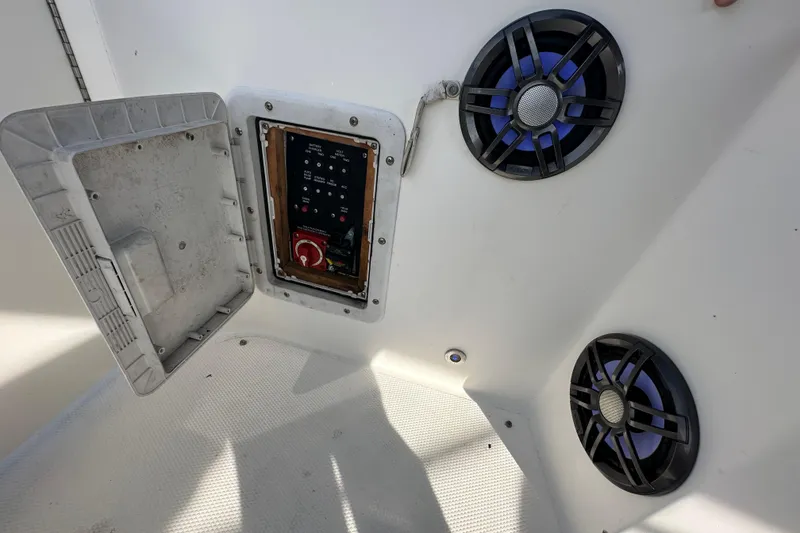 Slide: The Image of 2014 Larson Cabrio 265 boat interior with control panel and speakers. - 73
