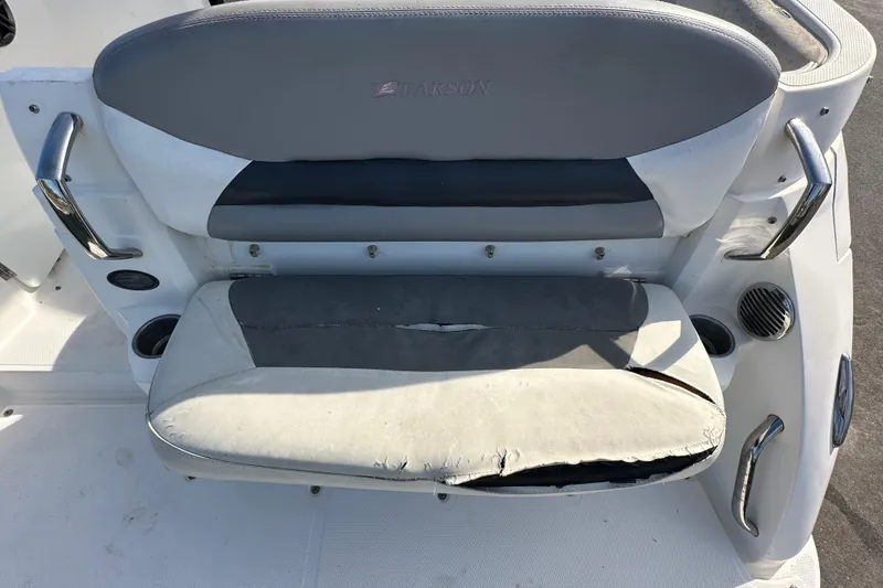 Slide: The Image of 2014 Larson Cabrio 265 boat seat with visible wear and tear. - 75