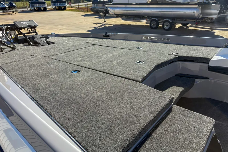 Slide: The Image of 2026 Skeeter ZXR20 SE boat deck with carpeted surface and storage compartments. - 10