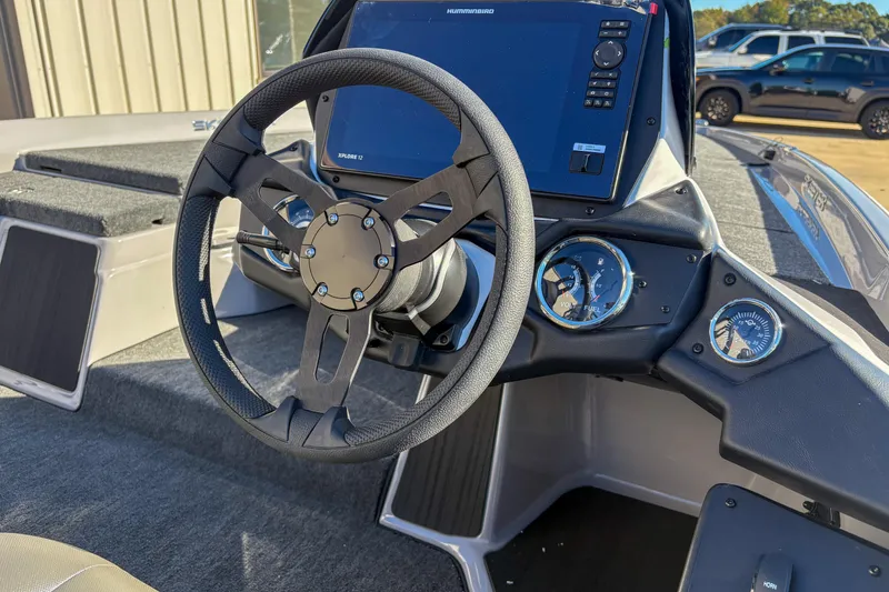 Slide: The Image of Steering console of 2026 Skeeter ZXR20 SE boat with digital display and gauges. - 12