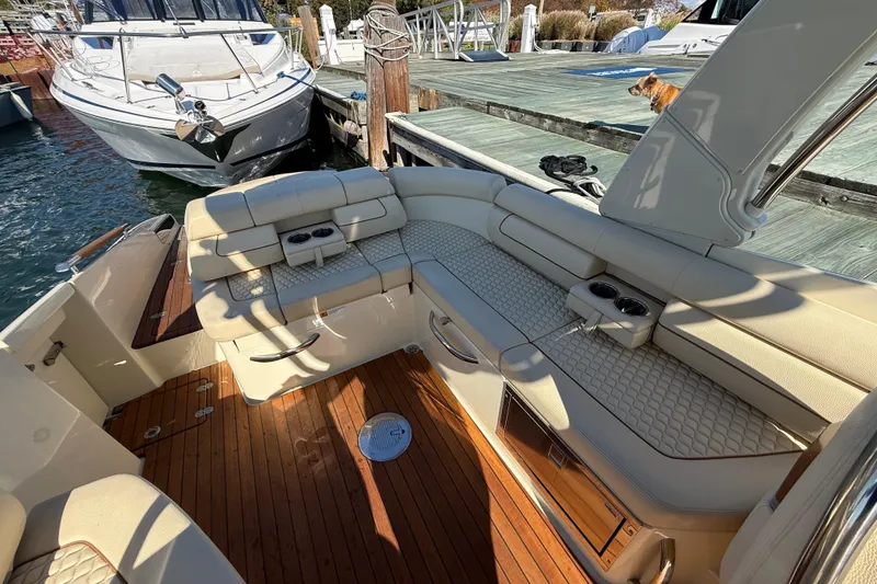 Slide: The Image of 2019 Chris-Craft Launch 28 GT boat interior with luxurious seating and wooden deck. - 10