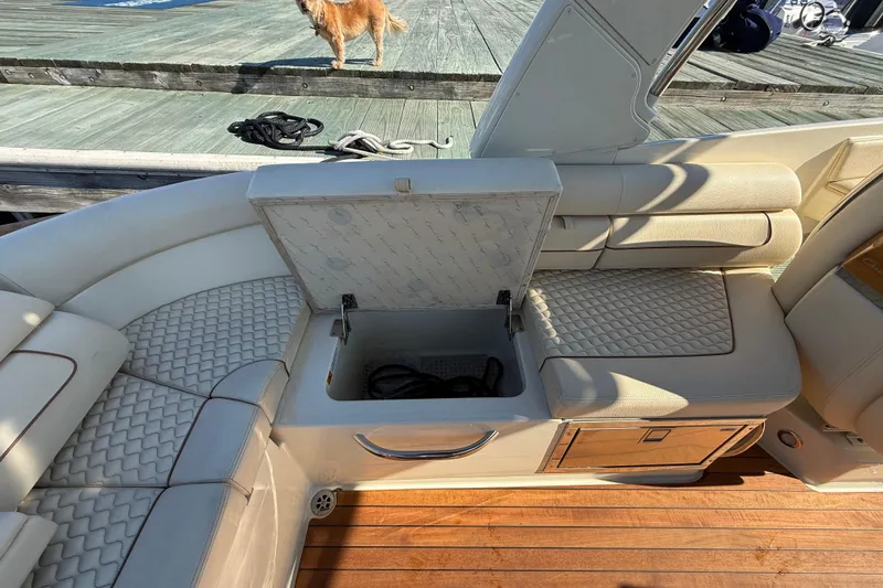 Slide: The Image of 2019 Chris-Craft Launch 28 GT interior with open storage compartment and luxurious seating. - 11