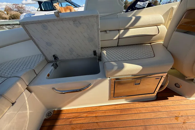 Slide: The Image of 2019 Chris-Craft Launch 28 GT interior with open storage compartment and luxurious seating. - 12