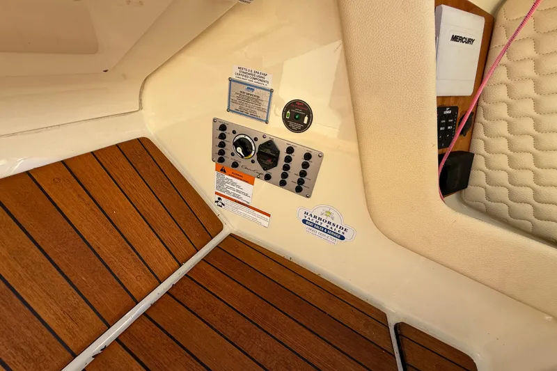 Slide: The Image of 2019 Chris-Craft Launch 28 GT interior with control panel and teak flooring. - 19