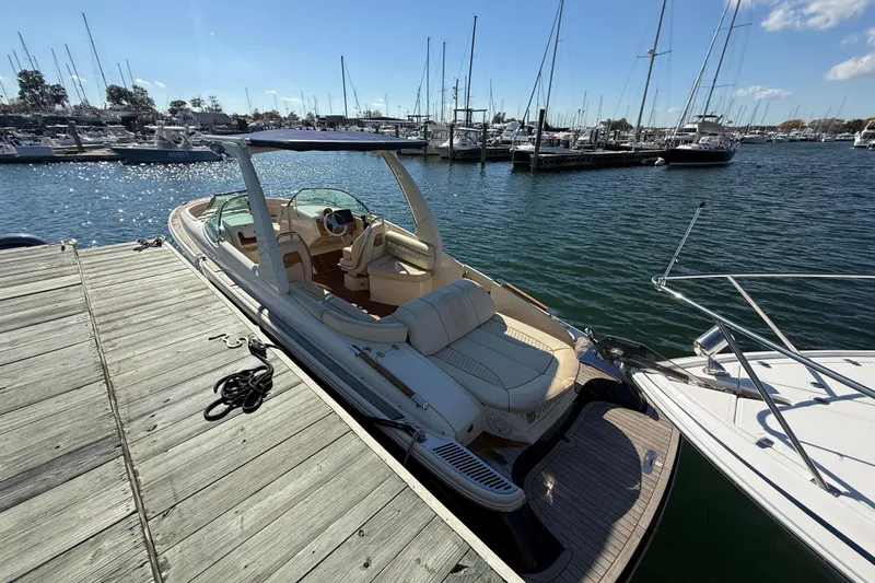 Slide: The Image of 2019 Chris-Craft Launch 28 GT docked at a marina, sunny day, calm waters. - 2