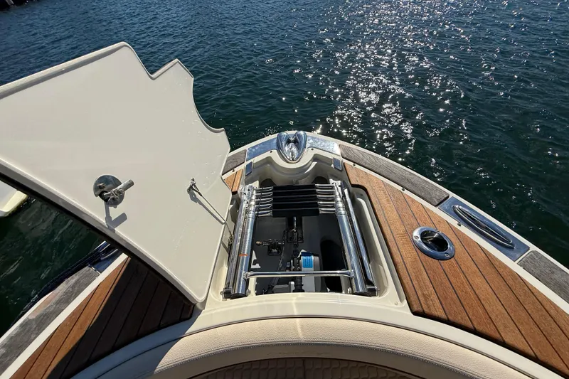 Slide: The Image of 2019 Chris-Craft Launch 28 GT boat with open storage compartment, docked on water. - 23
