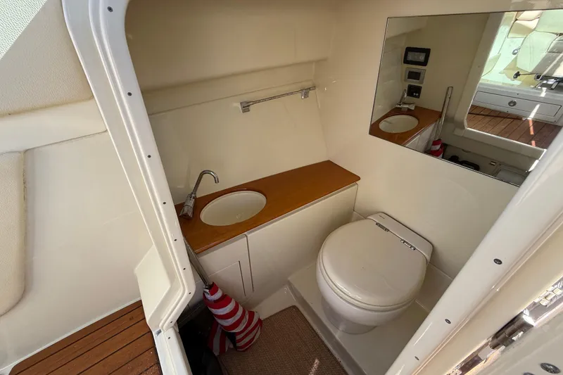 Slide: The Image of 2019 Chris-Craft Launch 28 GT boat interior with compact bathroom, sink, and mirror. - 25