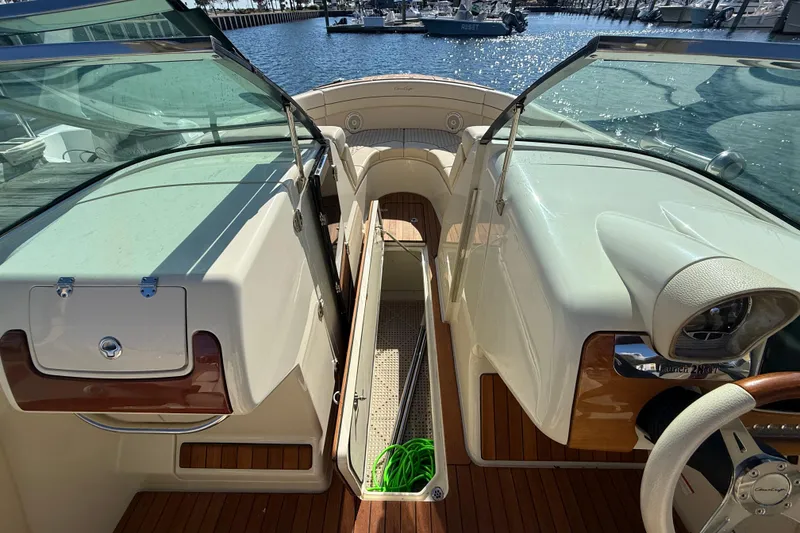 Slide: The Image of 2019 Chris-Craft Launch 28 GT interior with open deck and marina view. - 26