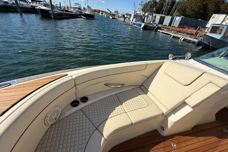 Slide: The Image of Luxurious 2019 Chris-Craft Launch 28 GT boat interior with beige seating at marina. - 28