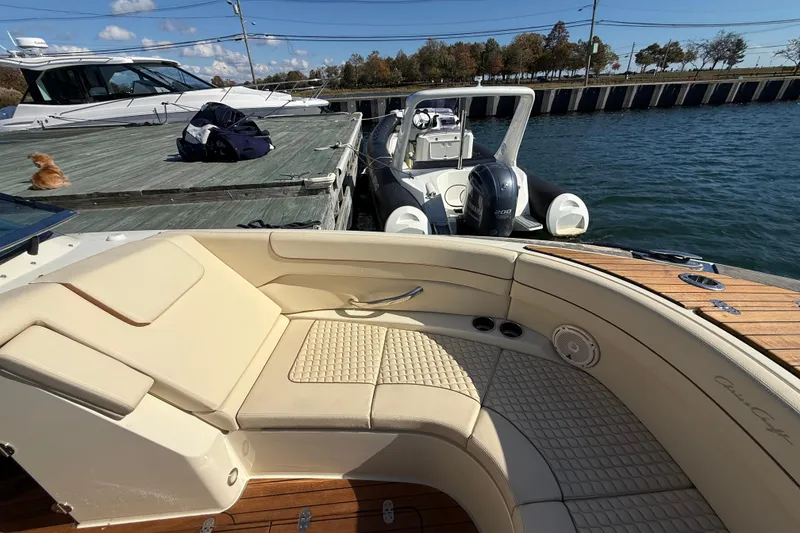Slide: The Image of 2019 Chris-Craft Launch 28 GT boat docked, featuring elegant seating and teak deck. - 29