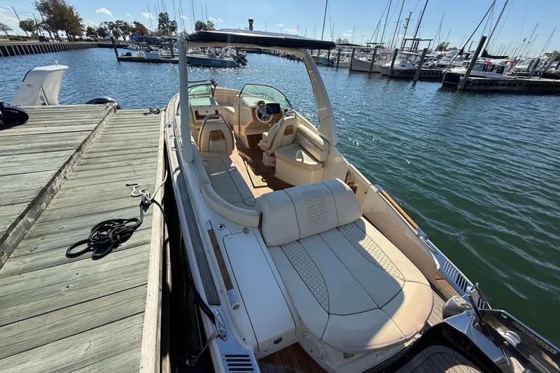 Slide: The Image of 2019 Chris-Craft Launch 28 GT docked at marina, showcasing luxurious seating and sleek design. - 3