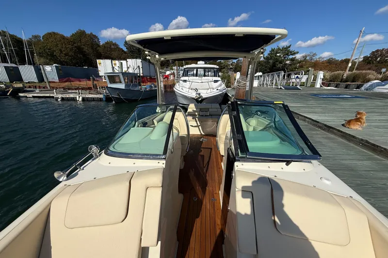 Slide: The Image of 2019 Chris-Craft Launch 28 GT docked, showcasing elegant seating and sleek design. - 30