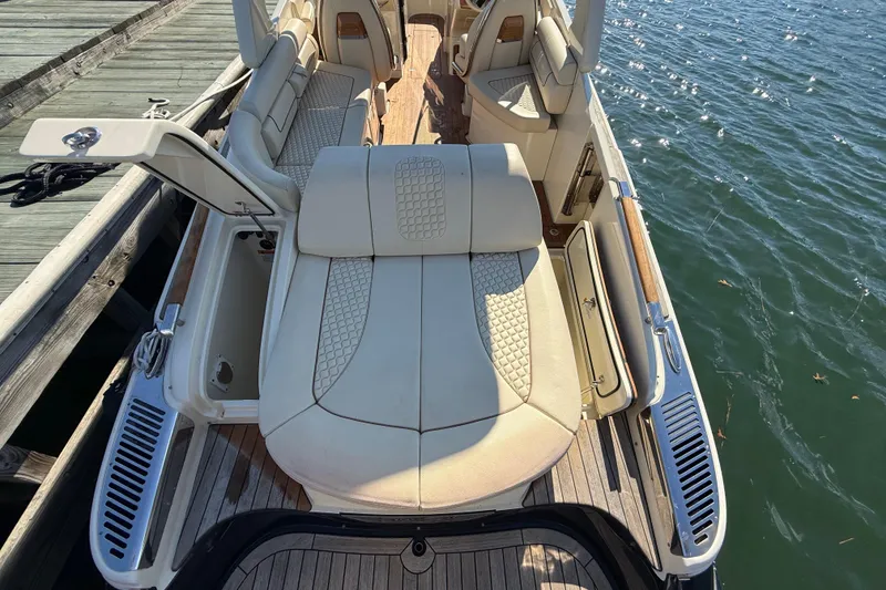 Slide: The Image of 2019 Chris-Craft Launch 28 GT boat interior with luxurious seating by the water. - 5